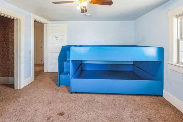 unfurnished bedroom featuring carpet floors and ceiling fan