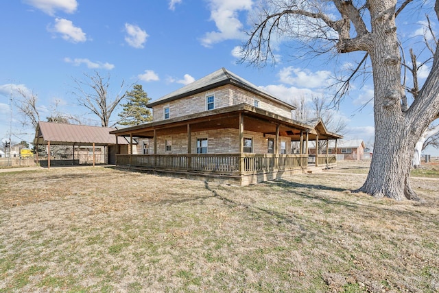 back of property featuring a yard