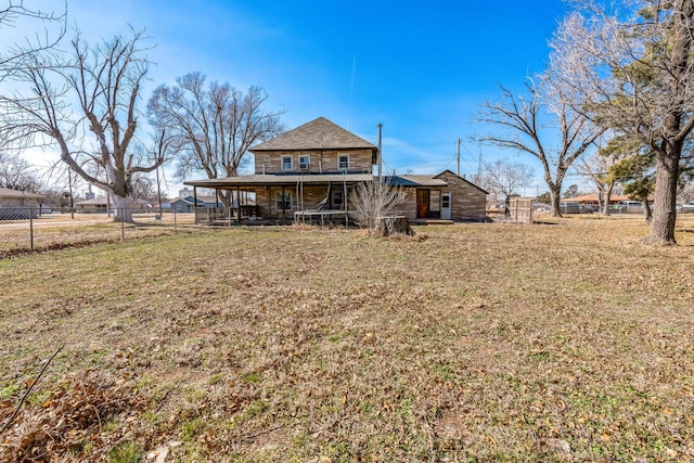 rear view of property with a lawn