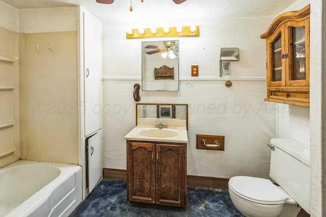 bathroom featuring vanity, ceiling fan, a bathing tub, and toilet