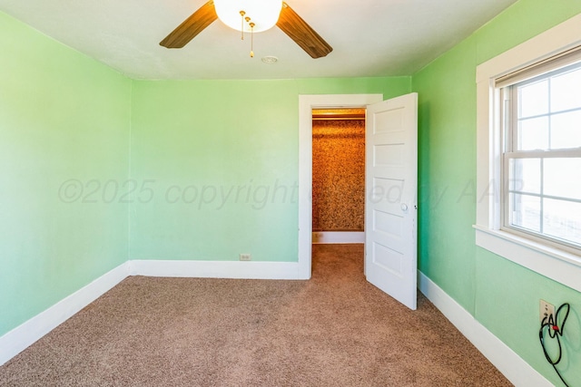 spare room with carpet flooring and ceiling fan