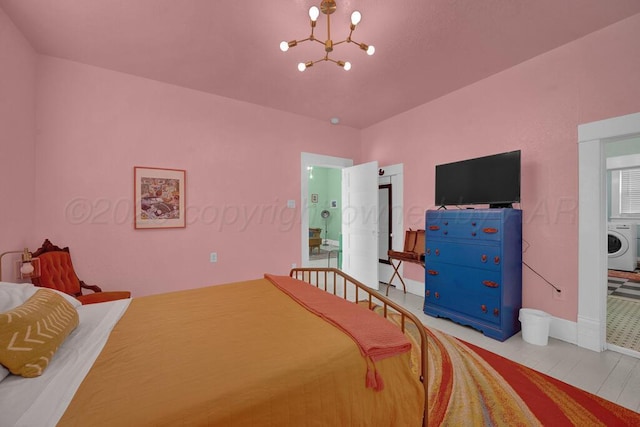 bedroom with washer / dryer, a chandelier, and baseboards
