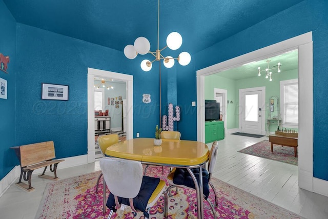 dining room with a chandelier and wood finished floors