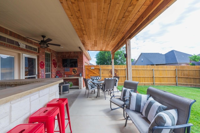 7409 Columbus Dr, Amarillo, TX 79118 - fenced backyard with a patio, outdoor dining space, and a ceiling fan