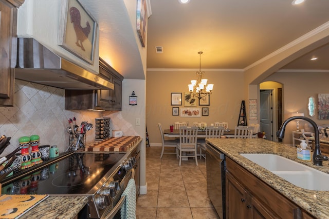 7409 Columbus Dr, Amarillo, TX 79118 - kitchen featuring stainless steel appliances, tasteful backsplash, arched walkways, a chandelier, and ornamental molding