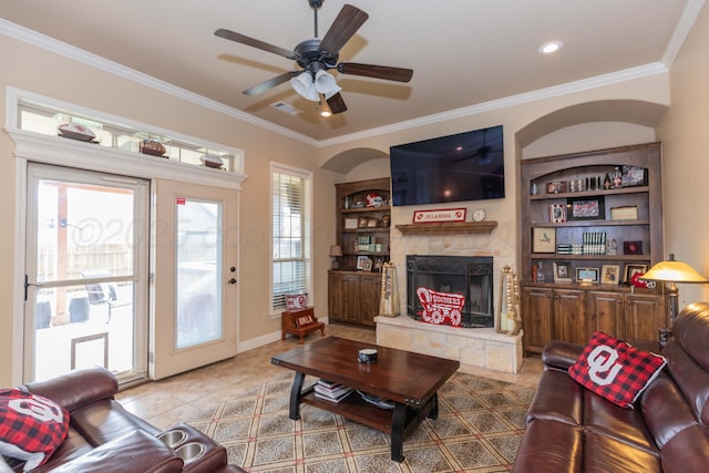 7409 Columbus Dr, Amarillo, TX 79118 - living area with tile patterned flooring, a ceiling fan, ornamental molding, a fireplace with raised hearth, and plenty of natural light