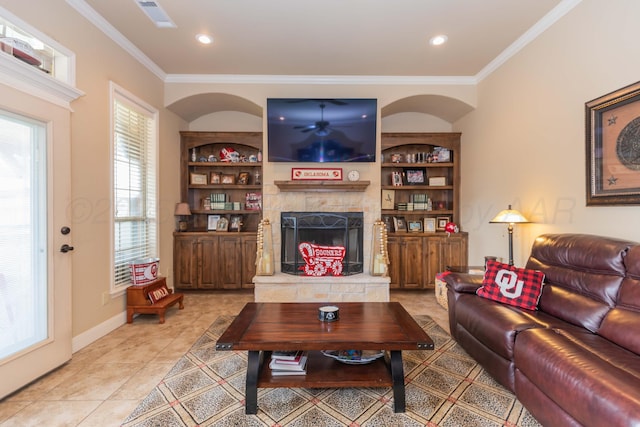 7409 Columbus Dr, Amarillo, TX 79118 - living area featuring a fireplace with raised hearth, crown molding, light tile patterned floors, built in features, and recessed lighting