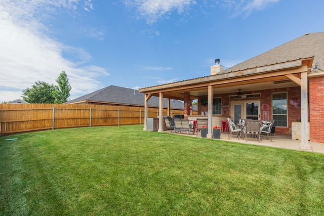 7409 Columbus Dr, Amarillo, TX 79118 - fenced backyard with a patio area and ceiling fan