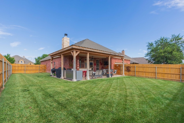 7409 Columbus Dr, Amarillo, TX 79118 - rear view of property with a chimney, a fenced backyard, ceiling fan, a patio area, and brick siding