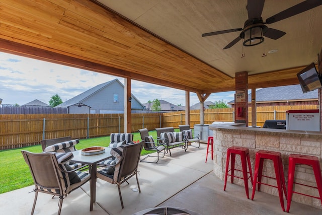 7409 Columbus Dr, Amarillo, TX 79118 - fenced backyard featuring a patio, outdoor lounge area, and a ceiling fan