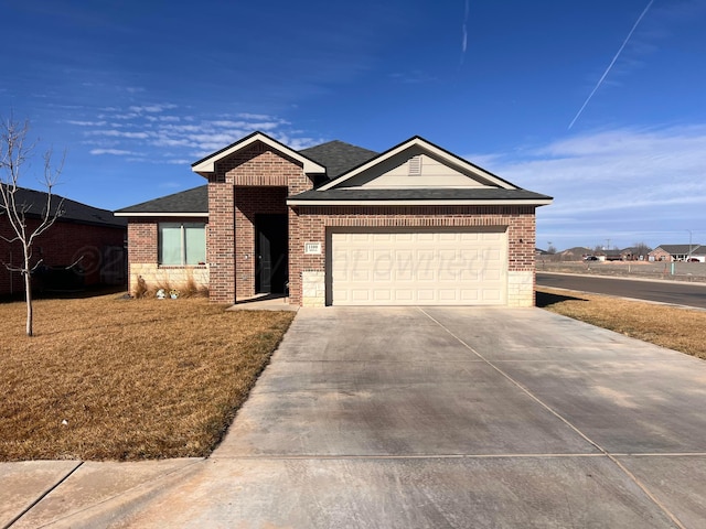 ranch-style house featuring an attached garage, brick siding, concrete driveway, roof with shingles, and a front yard