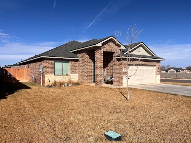 ranch-style home with a garage, driveway, brick siding, fence, and a front yard