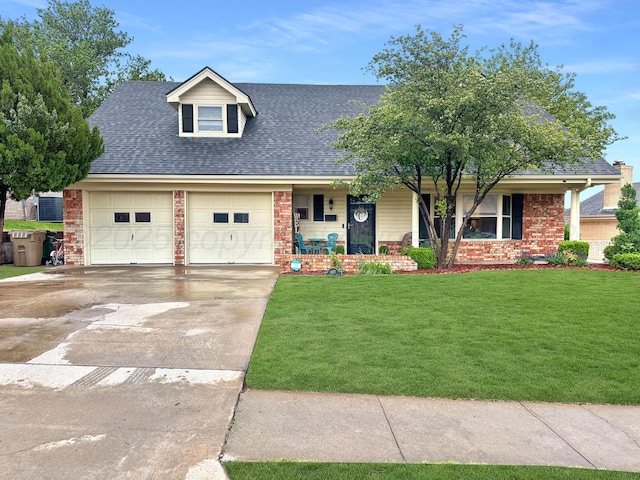 1417 Bluebonnet St, Borger, TX 79007 - view of front of property with covered porch, brick siding, a front lawn, an attached garage, and driveway