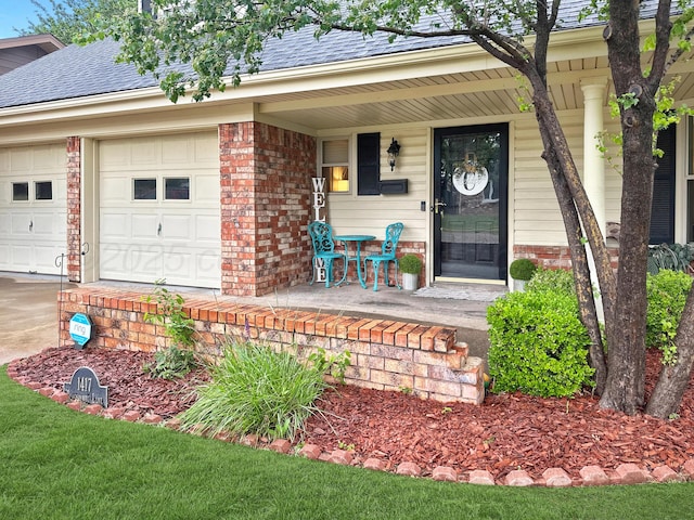 1417 Bluebonnet St, Borger, TX 79007 - entrance to property featuring a porch, roof with shingles, brick siding, driveway, and a garage