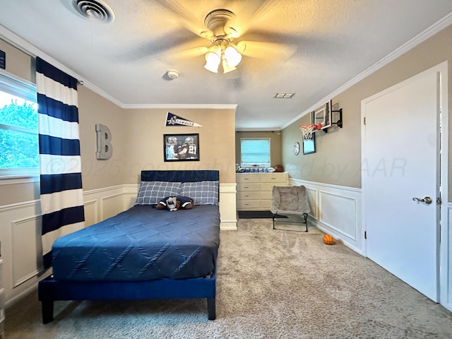 1417 Bluebonnet St, Borger, TX 79007 - bedroom with crown molding, a decorative wall, carpet flooring, a wainscoted wall, and ceiling fan