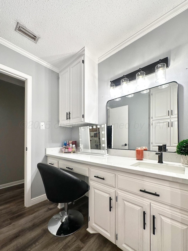 1417 Bluebonnet St, Borger, TX 79007 - bathroom featuring crown molding, wood finished floors, a textured ceiling, and vanity