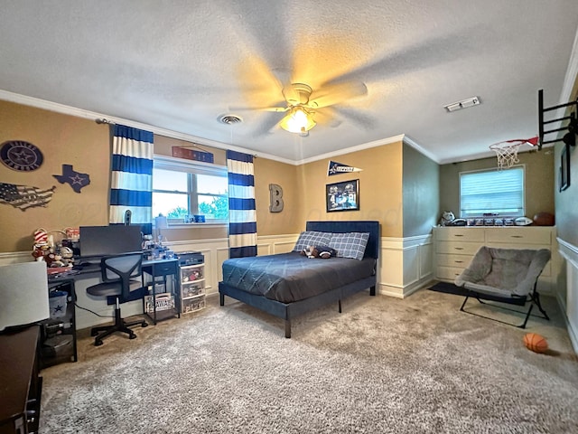 1417 Bluebonnet St, Borger, TX 79007 - carpeted bedroom featuring crown molding, multiple windows, an office area, a textured ceiling, and a wainscoted wall