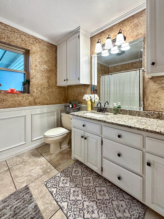1417 Bluebonnet St, Borger, TX 79007 - bathroom with crown molding, a wainscoted wall, toilet, a shower with shower curtain, and vanity