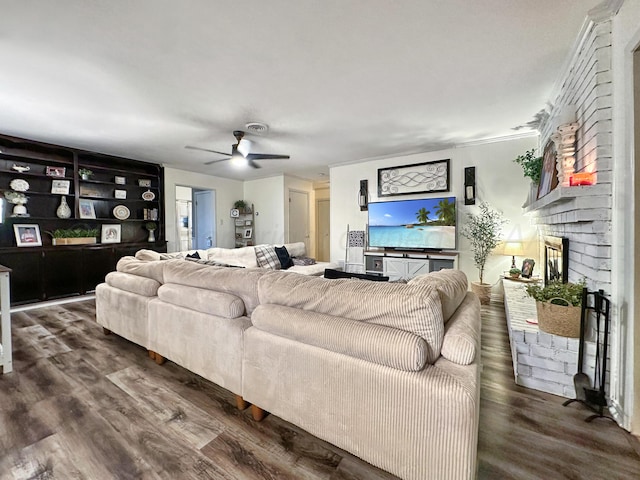 1417 Bluebonnet St, Borger, TX 79007 - living room featuring a ceiling fan, wood finished floors, a fireplace, and built in shelves