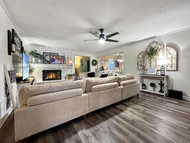 1417 Bluebonnet St, Borger, TX 79007 - living room featuring wood finished floors, ceiling fan, a fireplace, and ornamental molding