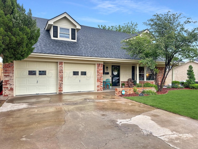 1417 Bluebonnet St, Borger, TX 79007 - view of front of home featuring a porch, driveway, roof with shingles, and brick siding