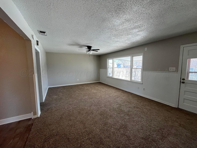 interior space with a textured ceiling and ceiling fan