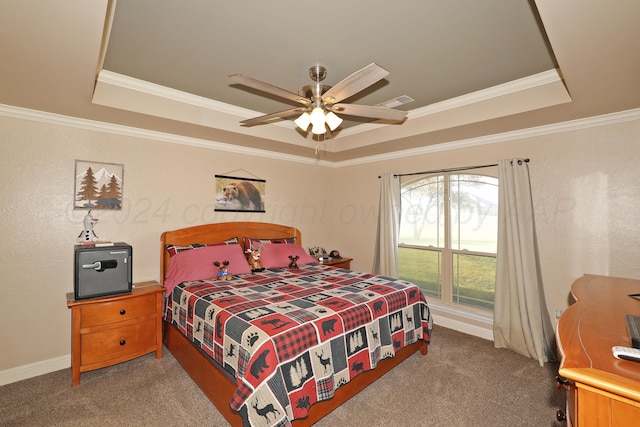 carpeted bedroom with ceiling fan, a raised ceiling, and ornamental molding