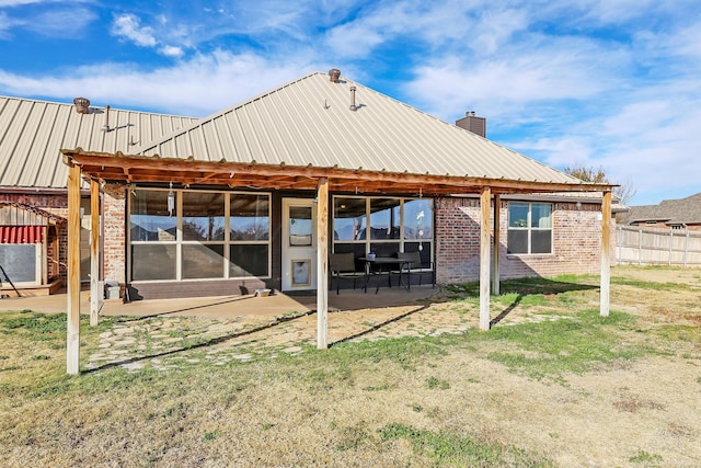 rear view of house featuring a yard and a patio