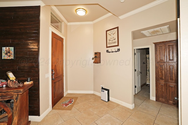 foyer entrance with light tile patterned floors and ornamental molding