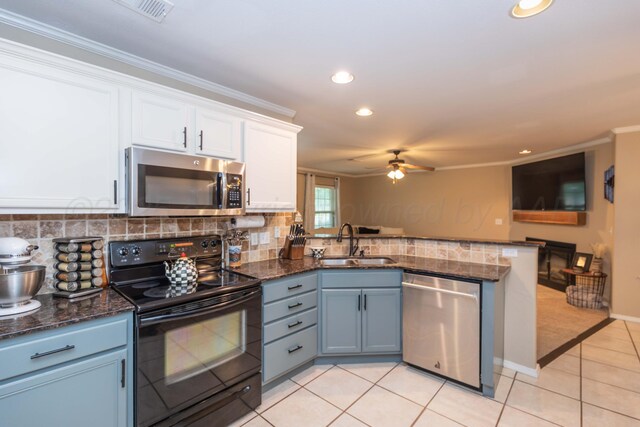 8507 Barstow Dr, Amarillo, TX 79118 - kitchen featuring stainless steel appliances, a peninsula, white cabinetry, a ceiling fan, and ornamental molding