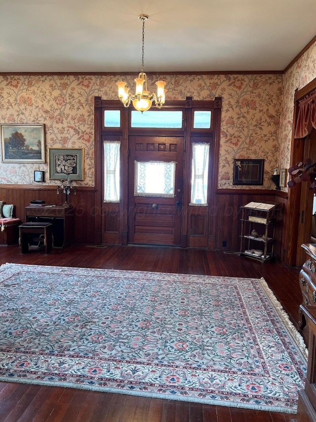 foyer featuring an inviting chandelier and dark wood-type flooring