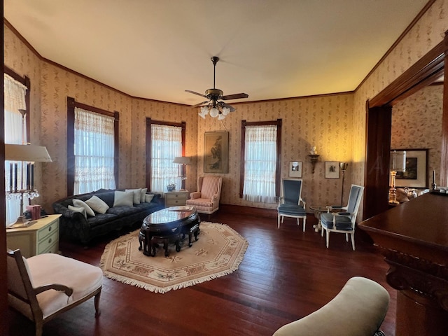 living room with ornamental molding, ceiling fan, and dark hardwood / wood-style flooring