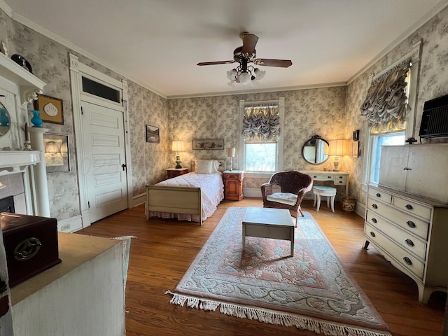 bedroom with hardwood / wood-style flooring, crown molding, and ceiling fan