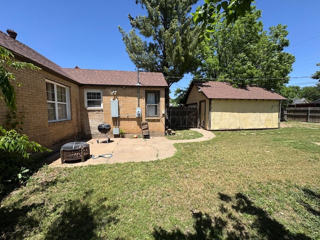 view of yard featuring a patio, an outbuilding, and a storage unit