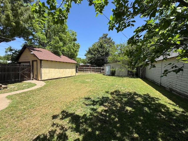 view of yard with a shed and an outbuilding
