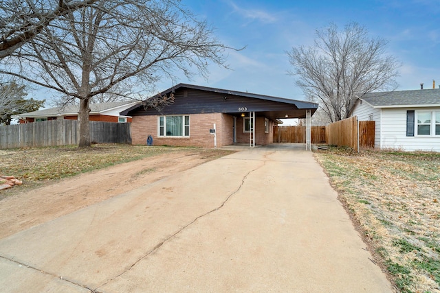 ranch-style home featuring a carport