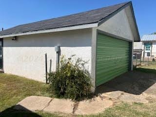 view of side of property with a garage and an outdoor structure