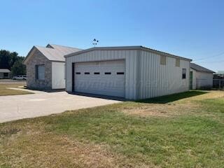 exterior space with a garage and a front lawn