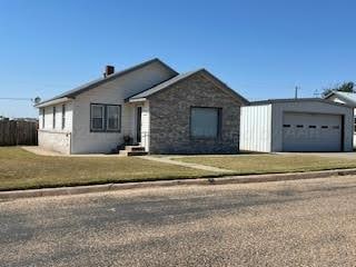 single story home with a garage and a front yard