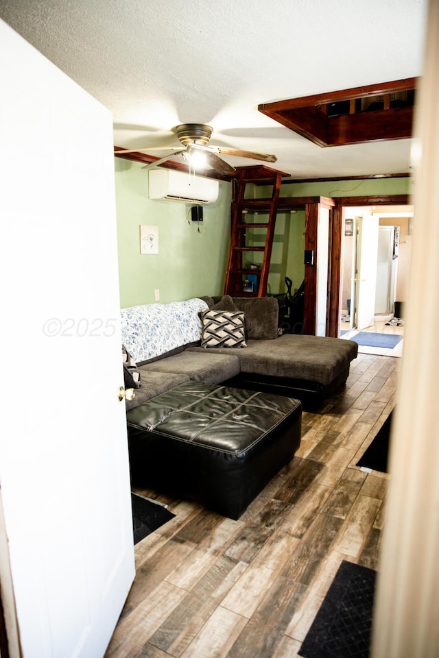 1611 S Palo Duro St, Amarillo, TX 79106 - living area featuring hardwood / wood-style floors, ceiling fan, a wall mounted air conditioner, and a textured ceiling