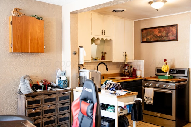 1611 S Palo Duro St, Amarillo, TX 79106 - kitchen with stainless steel range with gas cooktop and backsplash