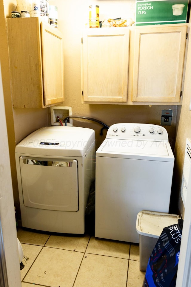 1611 S Palo Duro St, Amarillo, TX 79106 - laundry area featuring cabinet space, separate washer and dryer, and light tile patterned floors