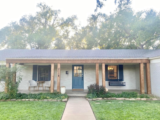 view of front of house with a front yard and covered porch