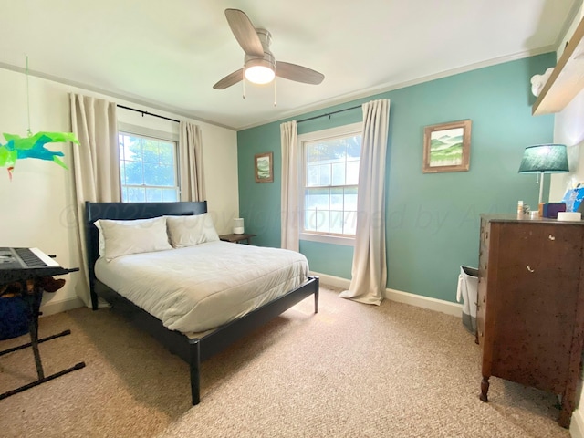 bedroom with light carpet, ornamental molding, and ceiling fan