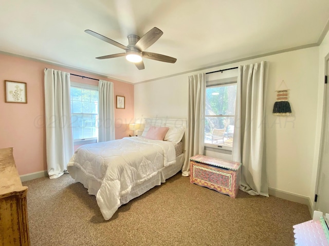 carpeted bedroom featuring ornamental molding and ceiling fan