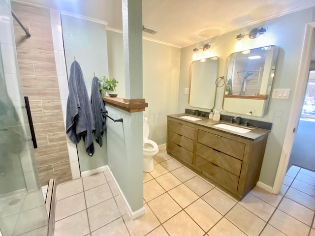 bathroom featuring vanity, tiled shower, toilet, crown molding, and tile patterned floors