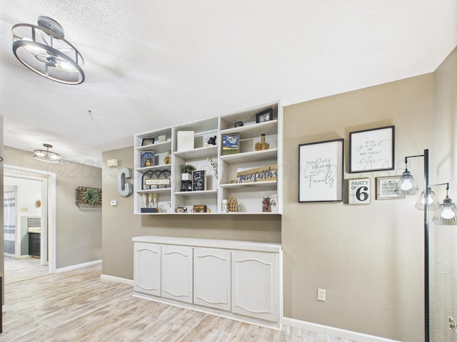 2600 Comanche Trl, Pampa, TX 79065 - hallway with light wood-style floors and a textured ceiling