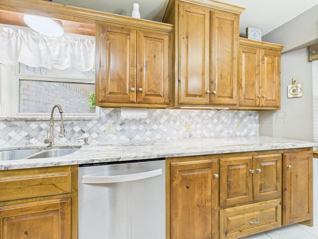 2600 Comanche Trl, Pampa, TX 79065 - kitchen featuring stainless steel dishwasher, decorative backsplash, and brown cabinetry