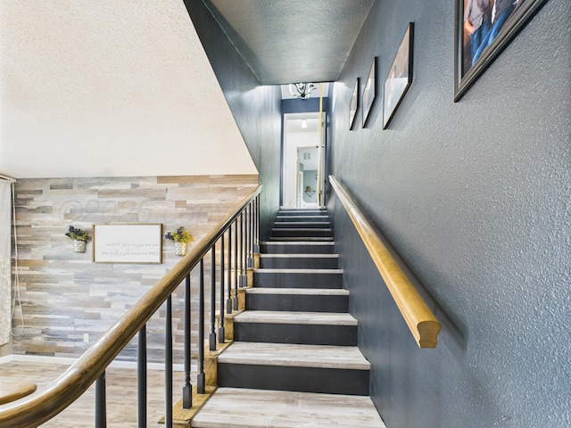2600 Comanche Trl, Pampa, TX 79065 - stairs featuring a textured wall, a textured ceiling, and wood finished floors