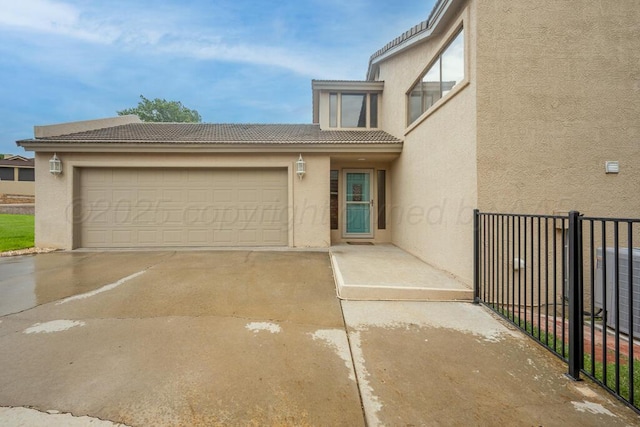 25 Crenshaw St, Amarillo, TX 79124 - view of front of house featuring stucco siding, a tile roof, an attached garage, and driveway